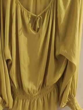 Yellow long sleeve elegant blouse with tie in the back.